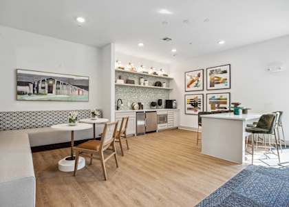a living room with a kitchen and a dining area at Radius on Grove, Austin, 78741