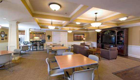 A large room with a long table and chairs.