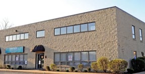 a large brick building with windows on a street