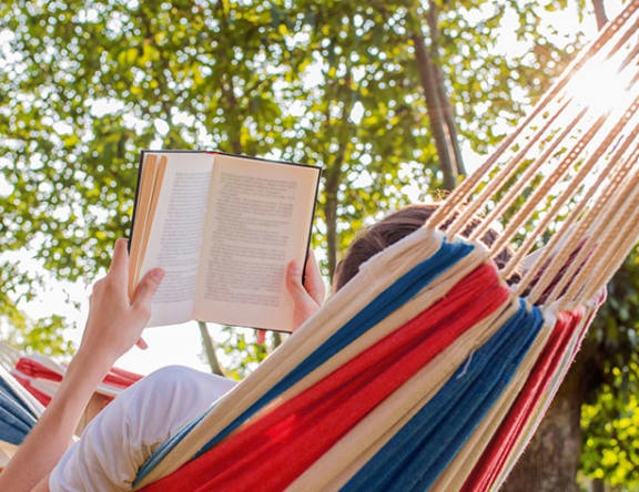 person reading on a hammock
