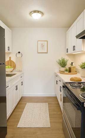 A modern kitchen with white chairs and a wooden floor.