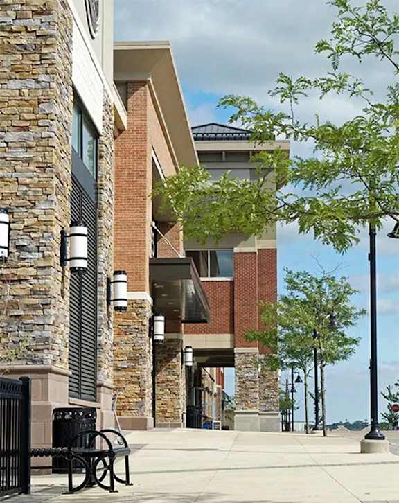 a building with a bench in front of it on a sidewalk