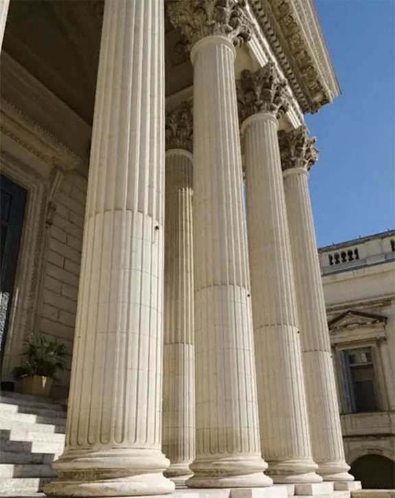 columns in front of a building with a blue sky