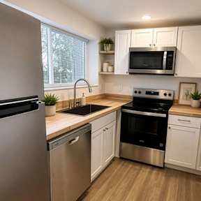 A modern kitchen with wooden floors and stainless steel appliances.