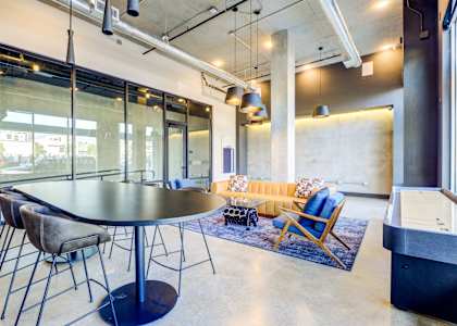 A modern dining room with a large table and chairs.