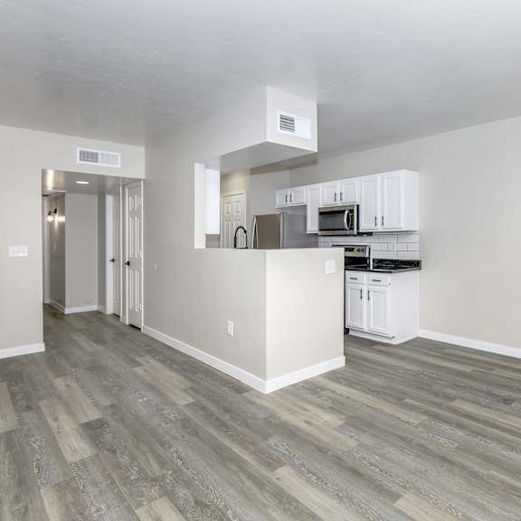 A kitchen with white cabinets and stainless steel appliances.
