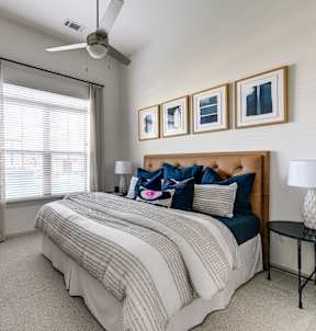 a bedroom with dark green walls and white bedding