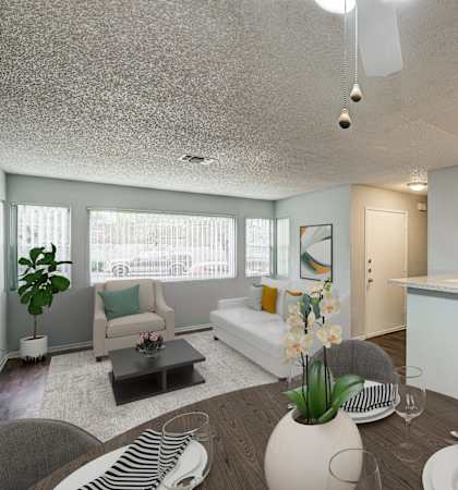 A modern kitchen with a dining table set for two.