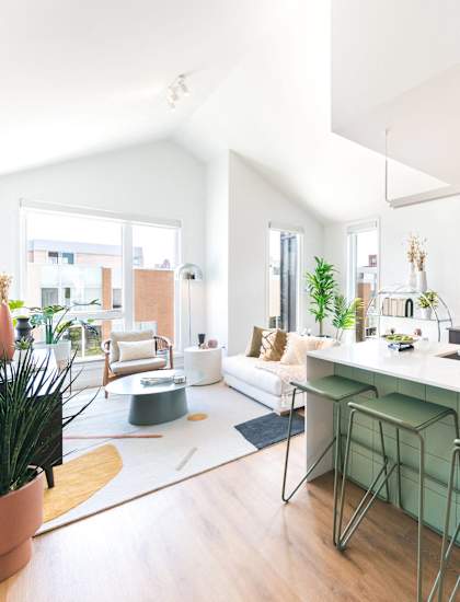 A modern kitchen with a bar stool and a countertop.