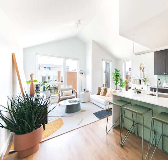 A modern kitchen with a bar stool and a countertop.