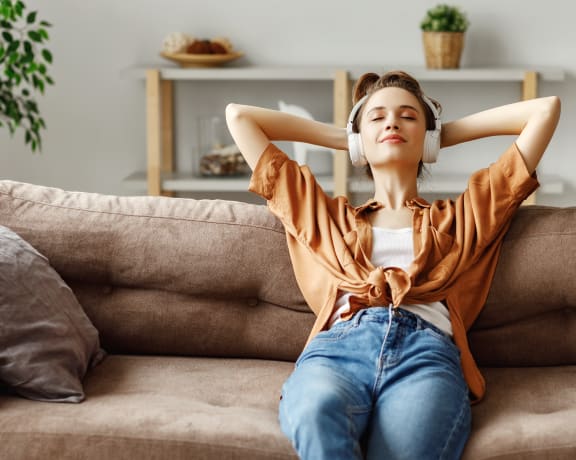 Lifestyle photo of a woman at home on the couch