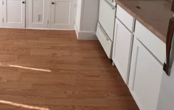 a kitchen with a stove top oven next to a sink