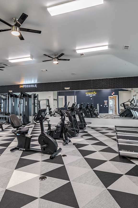 A gym with a PRECOR machine in the foreground.