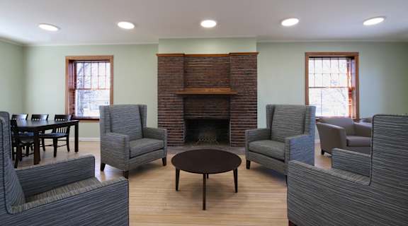 a living room with couches and chairs and a fireplace