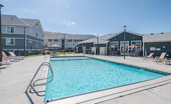 a swimming pool with apartments in the background