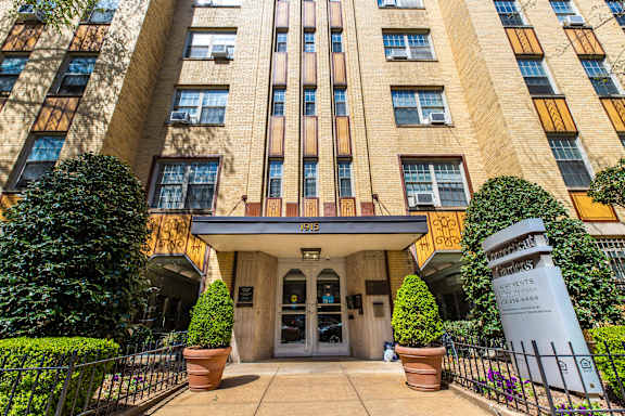 The image shows a tall building with a sign that reads "1915" on the front.