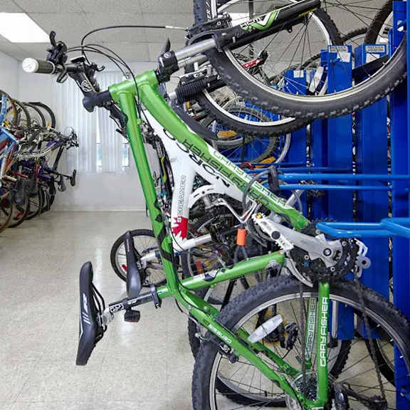 A green Can-Am bicycle is parked in a bike shop.