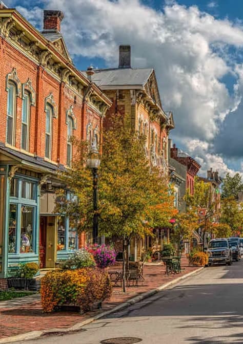 A row of old brick buildings line a street.