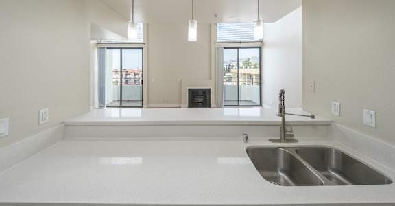 an empty kitchen with a sink and a window