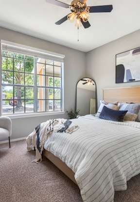 a bedroom with a bed and two windows at Bella Vista on Park, Florida, 33563