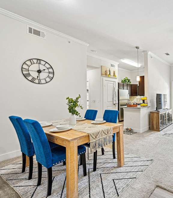 A dining room with a table and chairs.