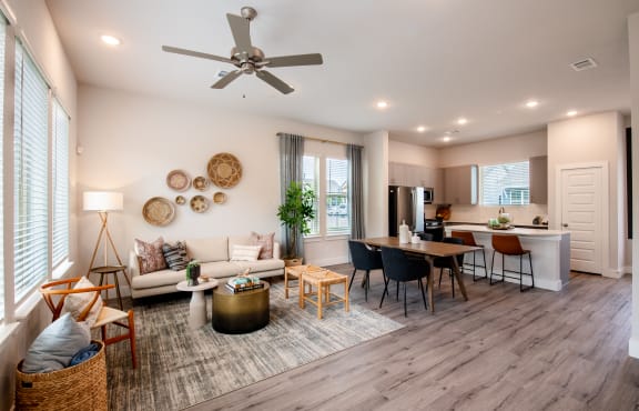 a living room with a couch and a table and a kitchen