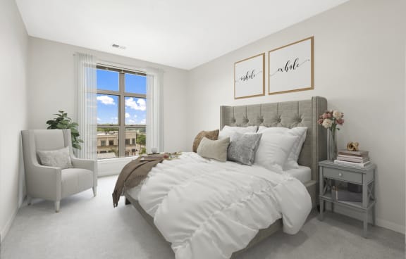 a bedroom with a large bed and two windows