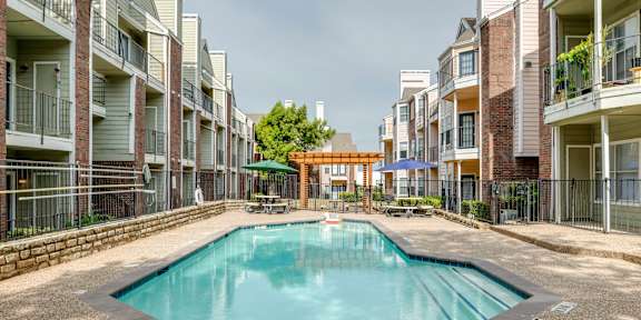 A swimming pool in the middle of apartment buildings.