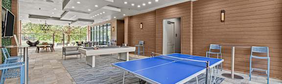 a game room with ping pong tables and a pool table