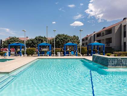 A large swimming pool with blue water and a clear sky above.