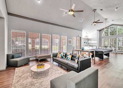 a living room with couches and chairs and a table
