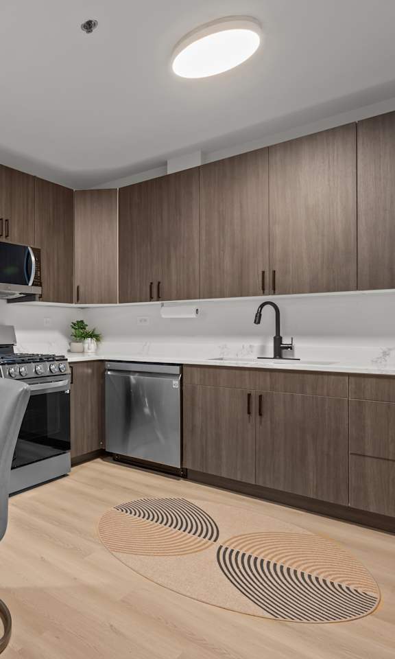 A modern kitchen with a dining table and chairs.