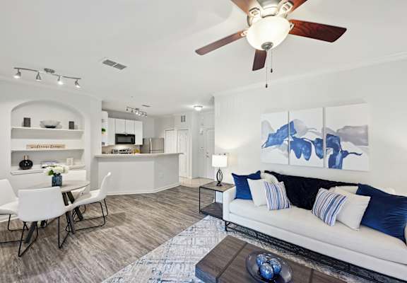a living room with a couch and a ceiling fan