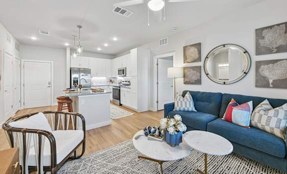 A modern living room with a blue couch and a coffee table.