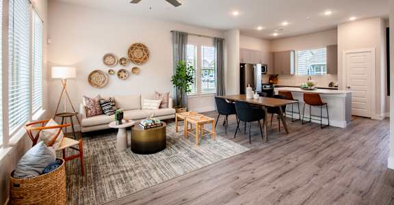a living room with a couch and a table and a kitchen
