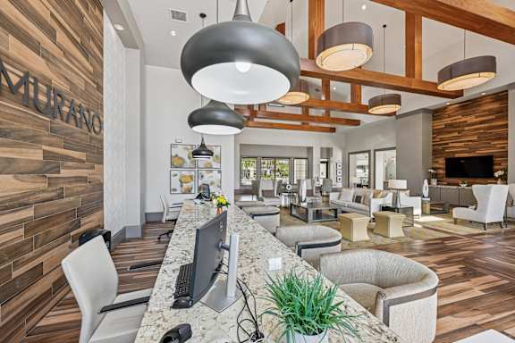 A modern office space with a reception desk and comfortable seating areas.