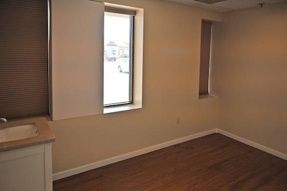 A room with a window and a sink.