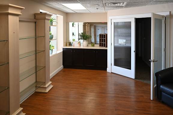 A room with wooden floors and a glass door.