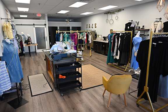 A clothing store with a variety of clothes on display.