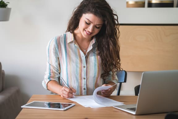 a woman signing a document