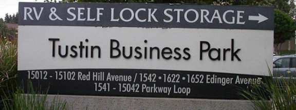 A sign for Tustin Business Park with an arrow pointing to the right for RV and self lock storage.