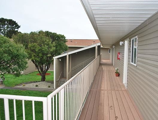 a house with a wooden deck and a fire hydrant
