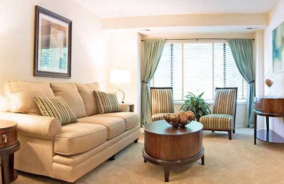 A living room with a couch, chair, and table.