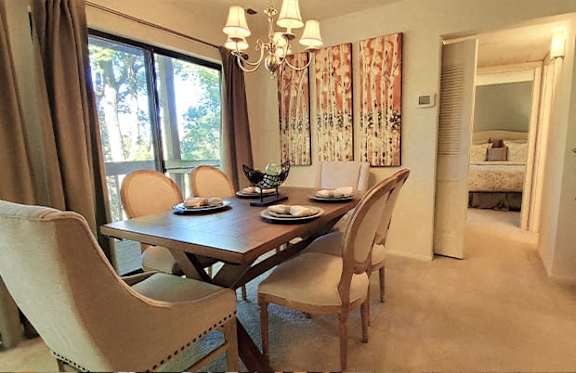 A dining room with a table set for four.