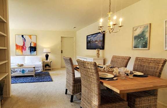 A dining room with a wooden table and chairs.