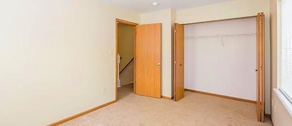 a bedroom with two doors and a window