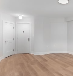 a living room with two couches and a rug and a dining room table