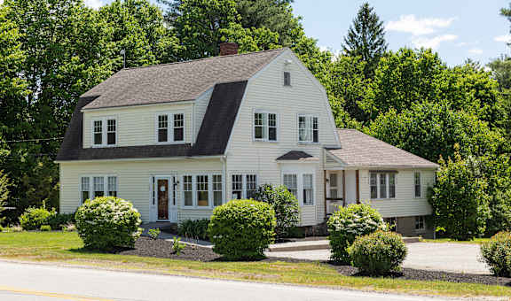 a house with a gray roof and white siding
