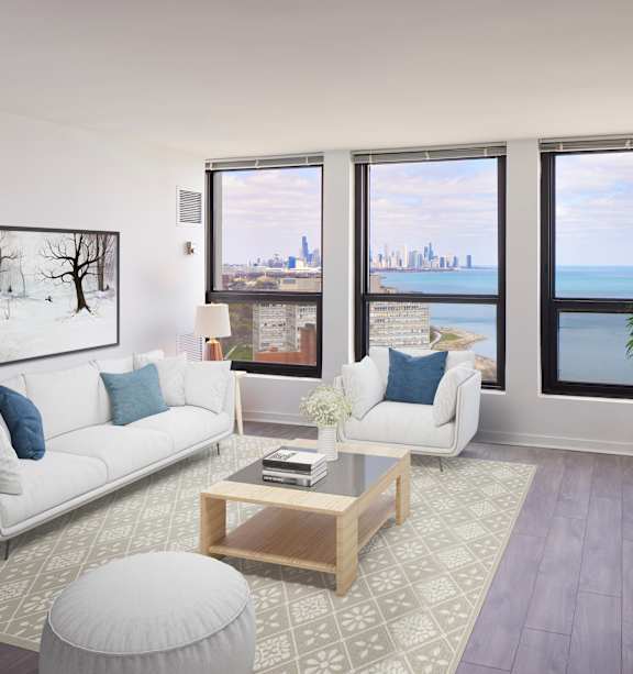 A living room with a white couch and a coffee table in front of a window.