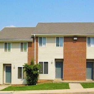 a row of houses with brick and white siding